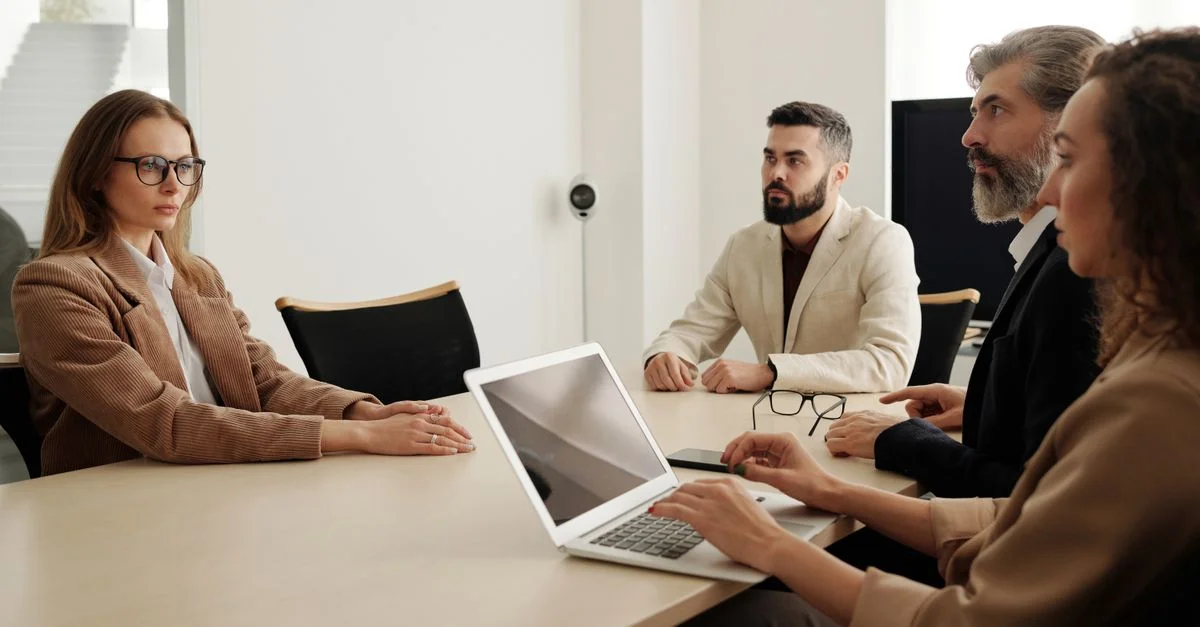 Réunion d'affaires avec une équipe diversifiée dans un bureau moderne, axée sur la planification et la coopération.