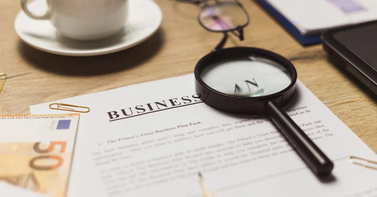 Un espace de travail professionnel avec des documents, du café et des éléments financiers.